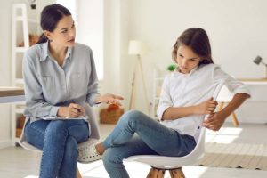 female therapist explaining to teenage girl the 4 common co-occurring disorders