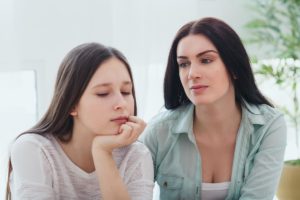 mother looking at teenager daughter wondering can family therapy help my teen