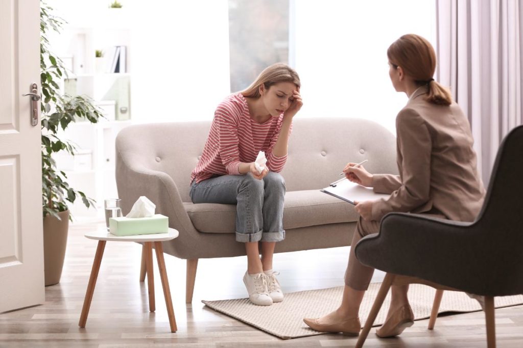 teenager girl talking to therapist wondering does my teen need psychotherapy