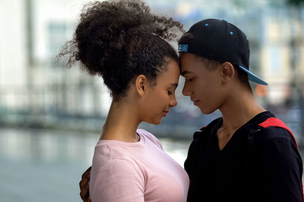 a teen couple embrace which is why talking to teens about relationships is important