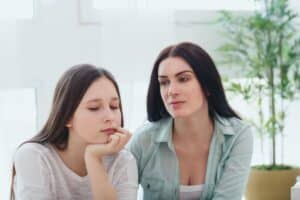 Mother talking to teenage daughter discussing how to help your teen de-stress