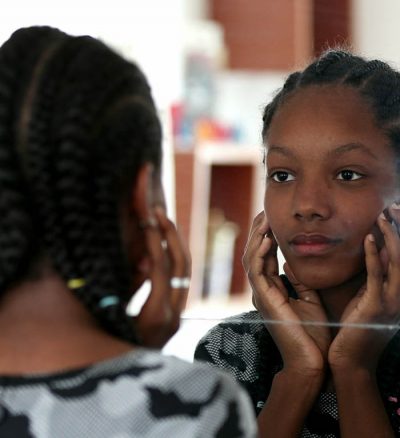 young girl looking in mirror